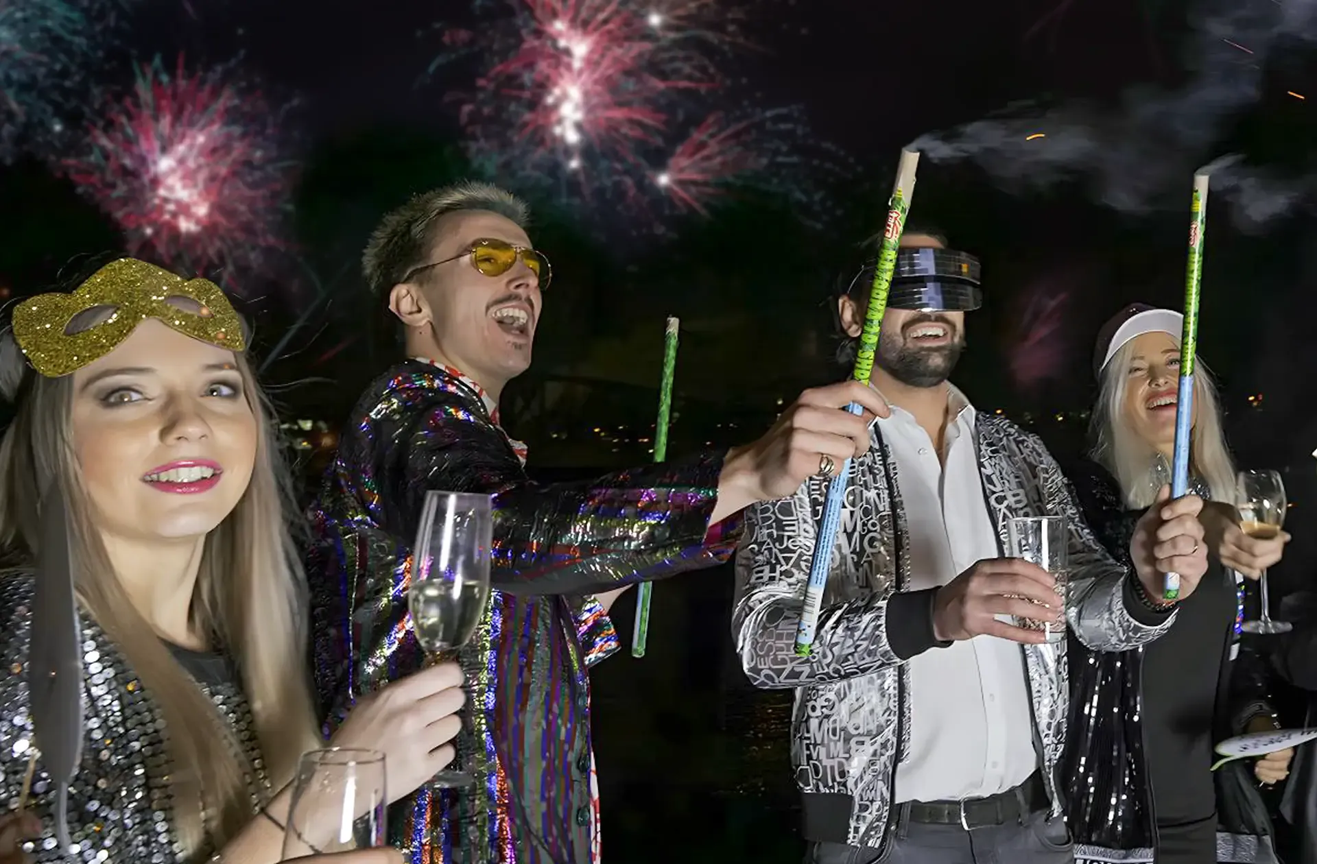 New Year's Eve on deck: guests with champagne and party poppers, fireworks behind